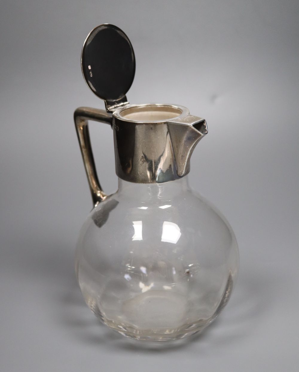 A late Victorian silver-mounted glass globular claret jug in the style of Christopher Dresser, Sheffield, 1897